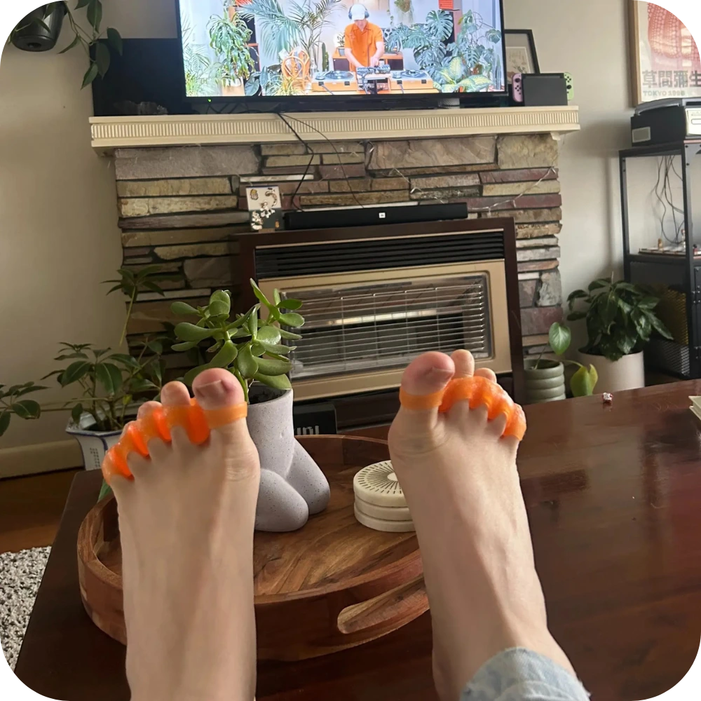 toe spacers on the couch in front of tv